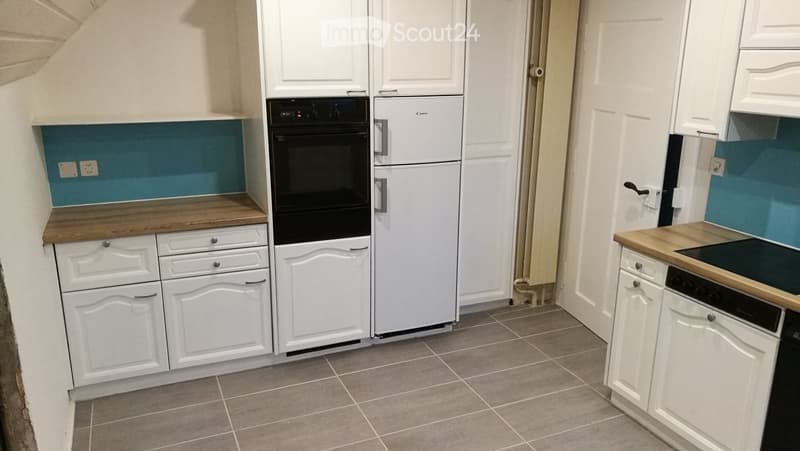 kitchen, white cabinetry, wooden counter top, appliances include fridge, oven, dishwasher and washing machine