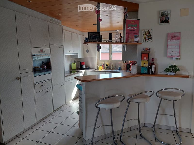 {"type": "Kitchen", "objects": ["cabinet", "bar stool", "oven", "coffee maker", "sink", "fridge", "bottle", "calendar", "picture frame", "stool", "bottle", "cup", "faucet", "bottle", "bottle", "bottle", "bottle", "bottle", "bottle", "bottle", "bottle", "b