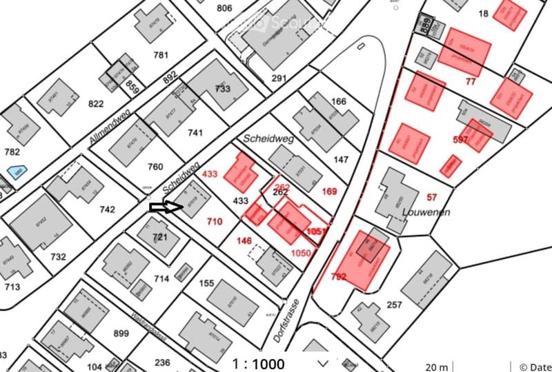 Floor plan showing multiple buildings and plots with numbered sections and labeled streets including Scheidweg, Dorfstrasse, and Almenweg.