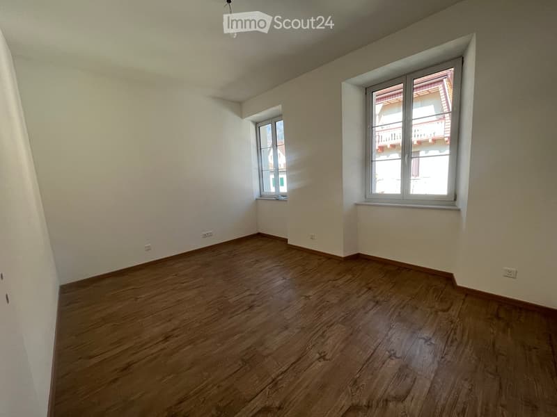 empty room, wooden floor, two windows, light fixtures