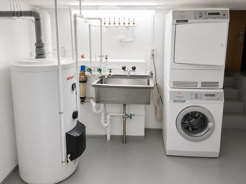 Modern utility room with a washing machine, water heater, and sink.