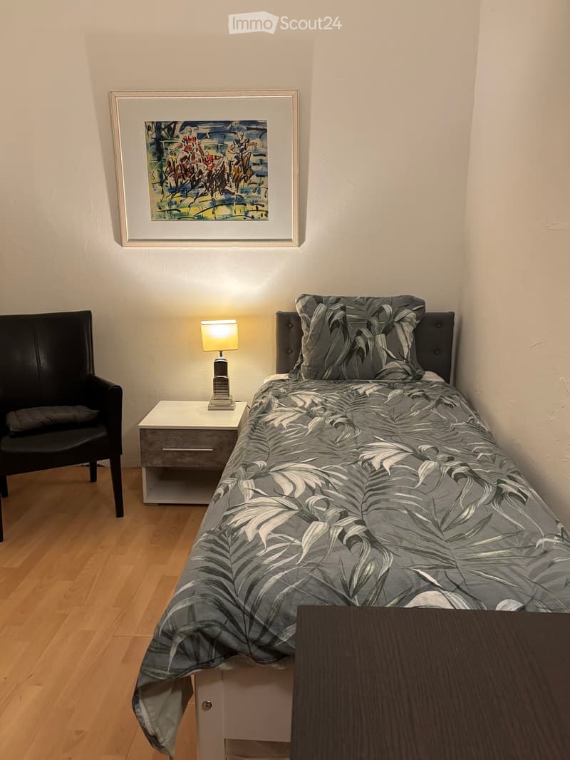 bed, bedside table, chair, painting