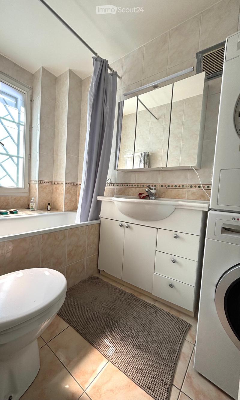Bathroom: Bathtub, White Toilet, White Sink, Mirror, White Cabinets, White Wash Machine