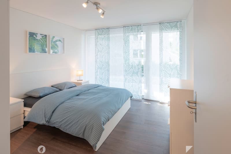 bedroom with bed, nightstands, lamps, wall pictures, window with shades