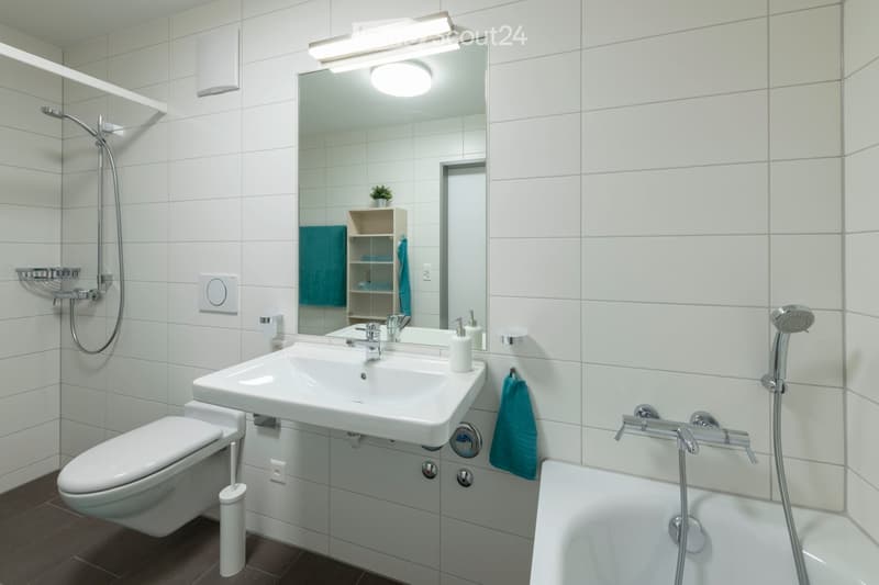 white tiles, white bathtub, sink, toilet, shower, towels, soap