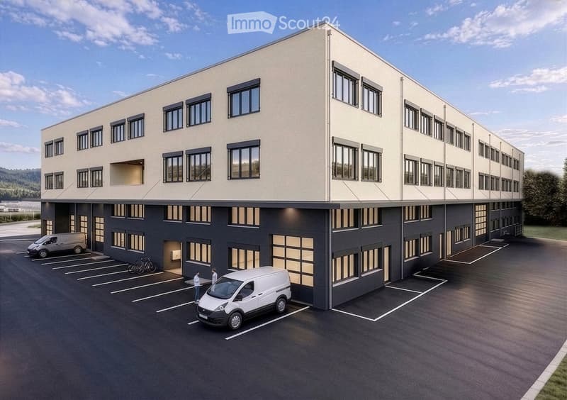 Modern two-story building with light beige upper facade and dark gray lower level, multiple windows, and a spacious parking lot with several vans and bicycles.