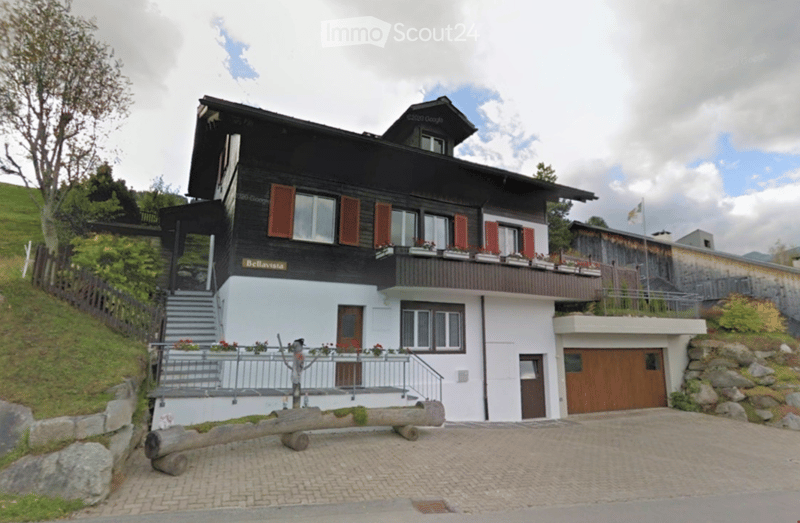 2 story house, black and white exterior, garage, balcony, flagged driveway
