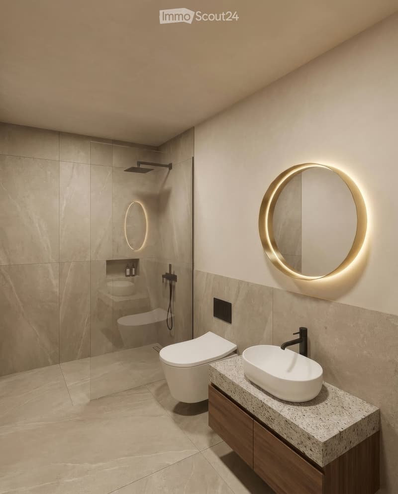 Modern bathroom with a sleek sink, round illuminated mirror, toilet, and glass-enclosed shower with a built-in seat and showerhead.