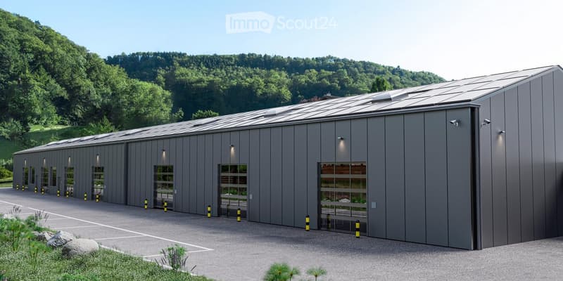 Modern industrial-style building with grey metal siding, large garage doors, and solar panels on the roof, surrounded by a paved parking area and greenery.