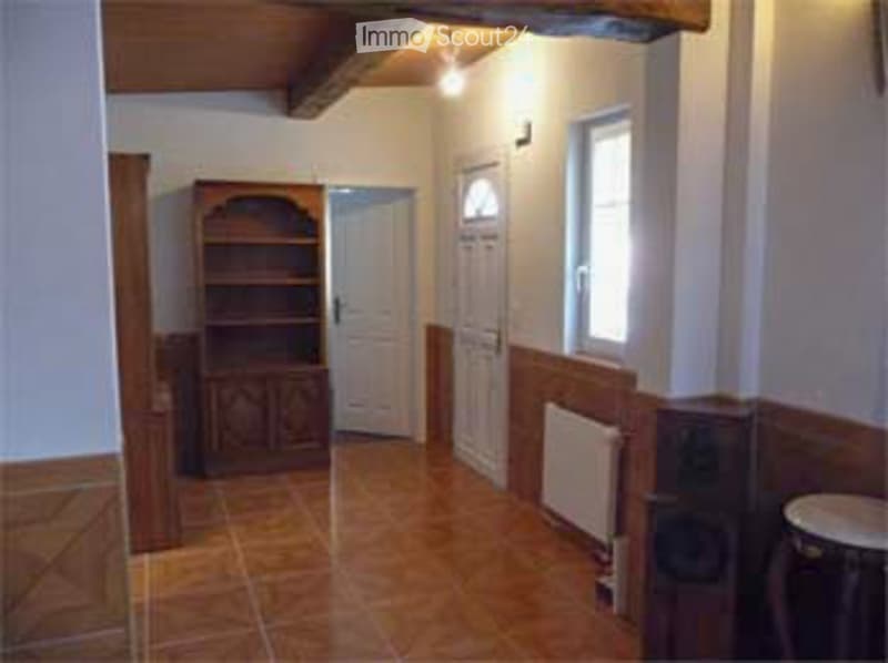 wooden cabinet, radiator, tiled floor, two white doors, window