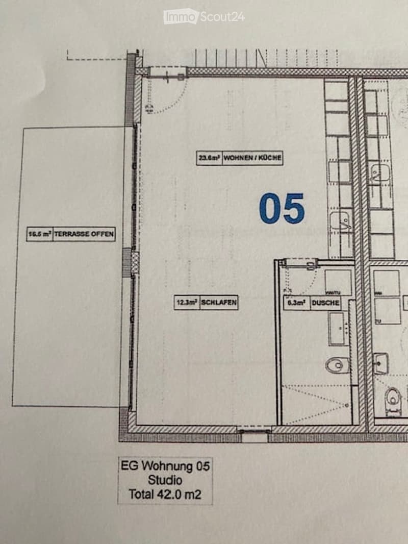 Floor plan of a studio apartment on the ground floor, including a living/kitchen area, bedroom, bathroom, and an open terrace.