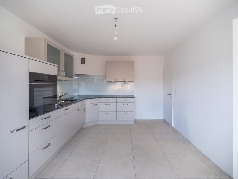 Modern kitchen with white cabinets, stainless steel appliances, and a sleek design.