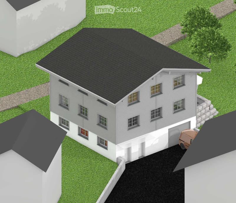 3-story house with grey siding, multiple windows, and a garage. The house is surrounded by a grassy area with a stone border.