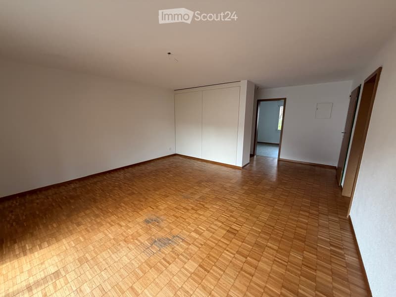 Empty room with wooden flooring, white walls, and a built-in closet. No furniture or equipment present.