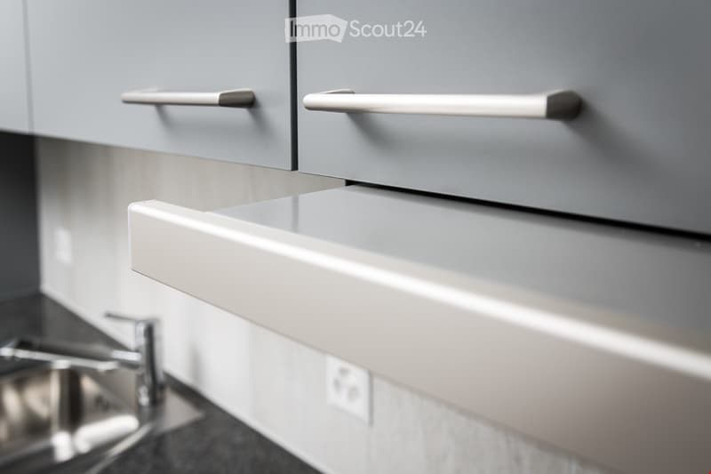 grey cabinets, stainless steel sink, outlet