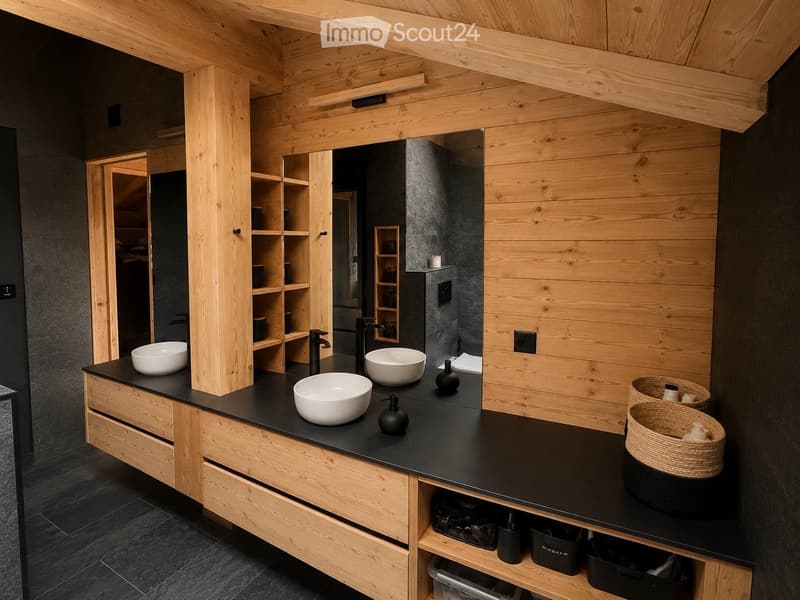 Modern bathroom with wooden walls and ceiling, black countertop, three white sinks, black faucets, and built-in wooden shelves and drawers.