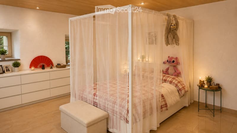 Cozy bedroom with a bed under a mosquito net, a white dresser, a small nightstand, a stool, and decorative items including a fan and toys.