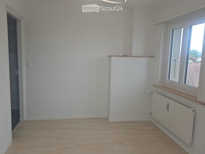 Unfurnished Room. Empty room with white walls, wooden flooring, and a window with a wooden sill. No furniture or equipment is present.