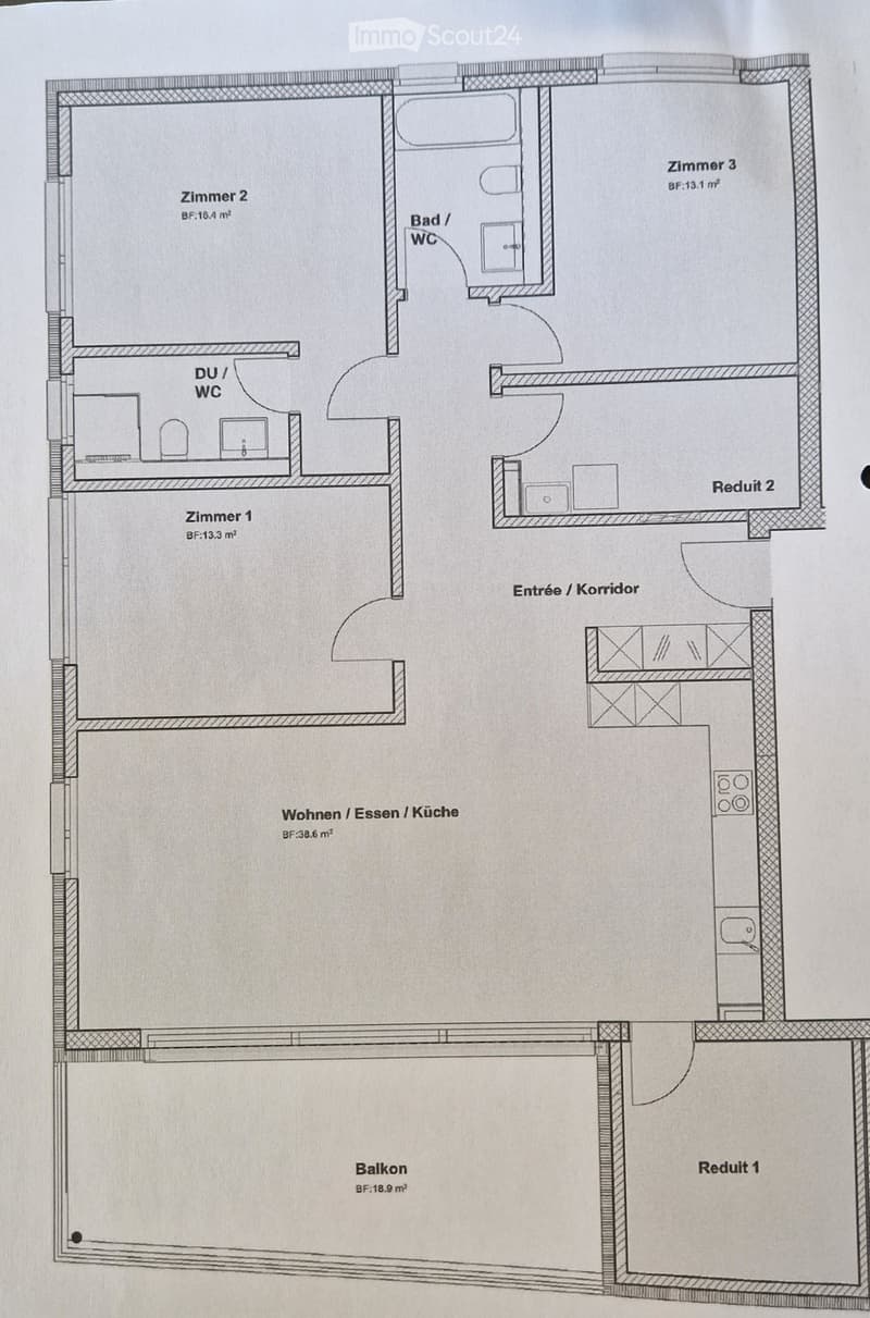 Floor plan showing a living/dining/kitchen area, three bedrooms, two bathrooms, two walk-in closets, a hallway, and a balcony.