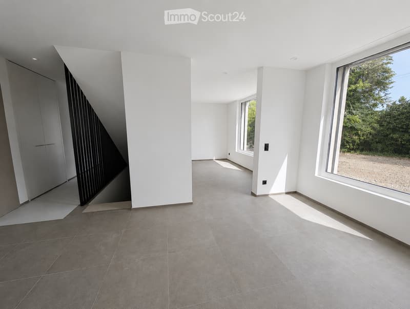 Empty room with white walls, large windows, and tiled floor. No furniture or equipment present.