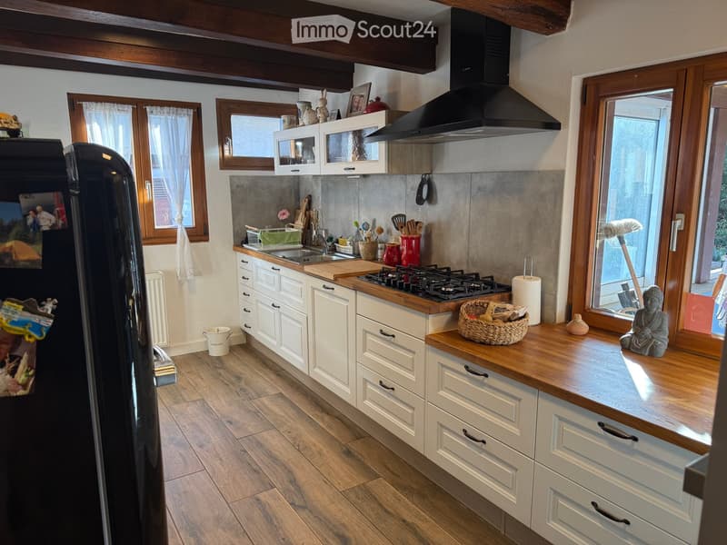 {"type": "Kitchen", "objects": ["refrigerator", "sink", "faucet", "gas stove", "cabinets", "cutting board", "faucet", "basket", "statue", "curtain", "microwave", "fridge", "cupboard", "cupboard", "cupboard", "cupboard", "cupboard", "cupboard", "cupboard",