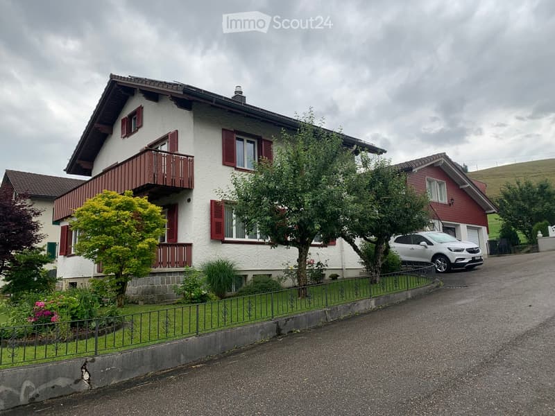 2 story house, white exterior, red shutters, balcony, driveway, parked car