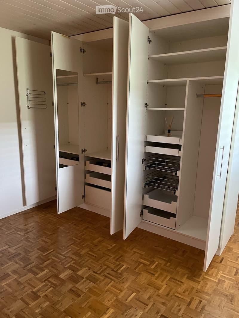 large white wardrobe, wooden floor, open drawers