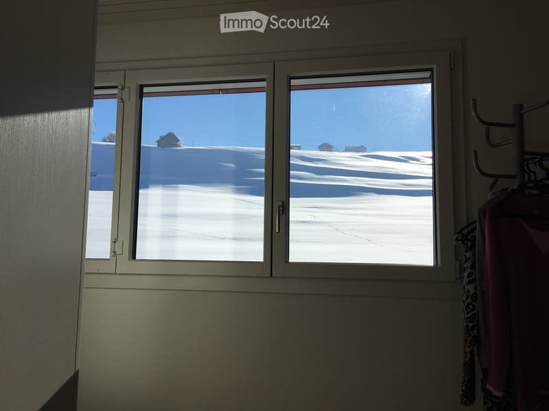 window, view of snowy hills and small houses