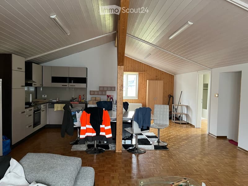 kitchen with dining table, couch with pillows, parquet flooring, white walls, white ceiling, wooden columns, mounted lights