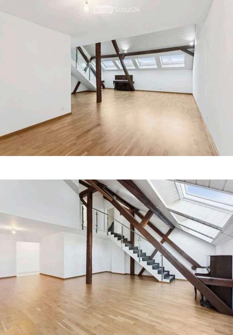 Empty room with wooden flooring, white walls, and exposed wooden beams. A staircase leads to an upper level, and there is a piano in the background.