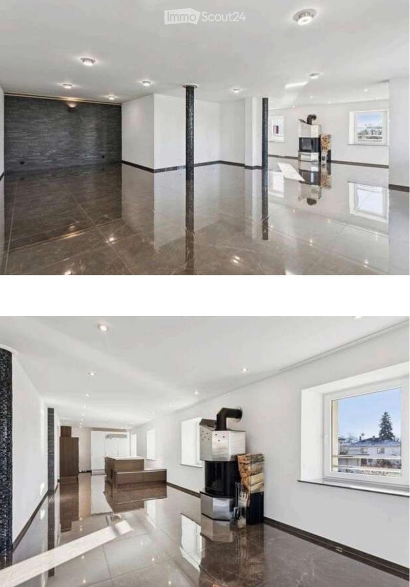 Modern, well-lit hallway with white walls, polished tile flooring, recessed ceiling lights, and a fireplace area visible at the end.