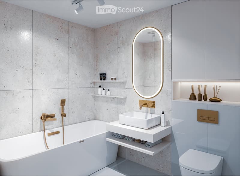 Modern bathroom with a white bathtub, floating sink, toilet, and decorative shelves holding toiletries and vases. Features a large, oval mirror with a gold frame and sleek brass fixtures.