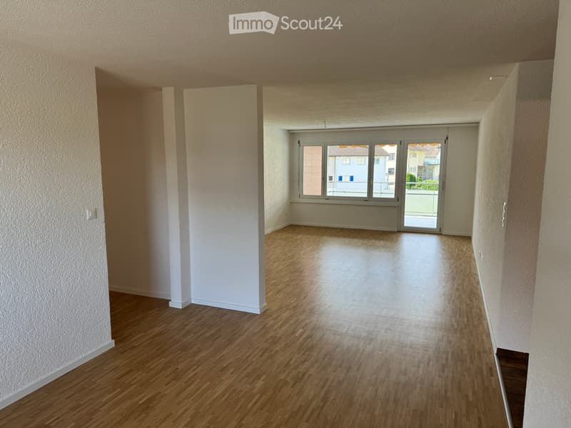 empty room, wooden floor, large window, sliding door leading to balcony