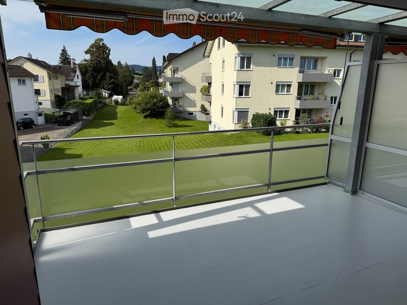 balcony, metal railings, view of a well-maintained grassy area and neighboring houses