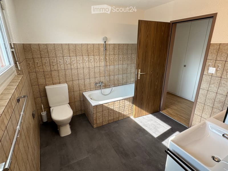 Bathroom with bathtub, shower, toilet, and sink.