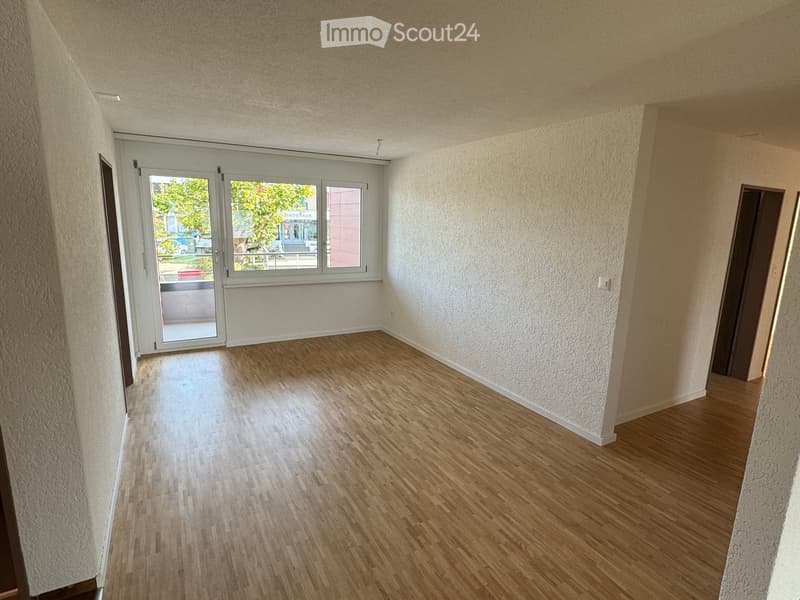 large windows, balcony, wooden floor, white walls, blank room