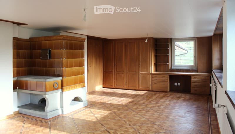 Empty room with wooden cabinets, tiled floor, and a fireplace. No furniture or equipment present.
