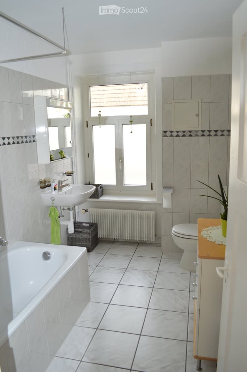 white tiles, bathtub, sink, toilet, radiator, window, plant
