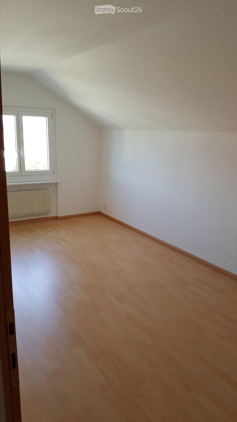 Empty room with wooden flooring, white walls, and a window with white frame. No furniture or equipment present.