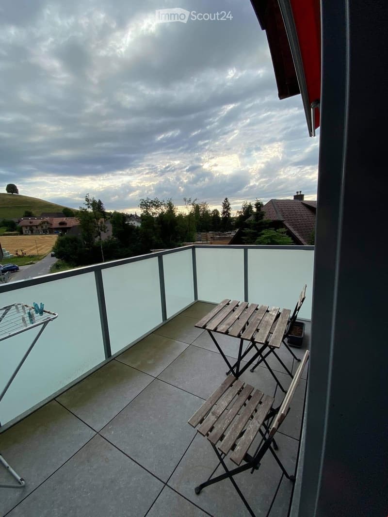 glass fence, wooden folding chairs, small wooden table, clothesline