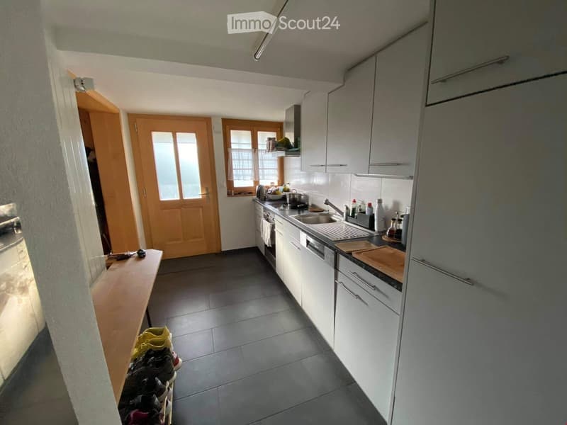 Tiled floor, stainless steel appliances, wooden shelves, bright lighting
