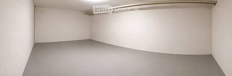 Empty room with white walls and grey floor, no furniture or equipment.