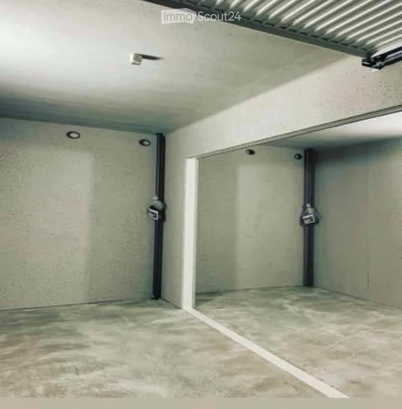 {"visible_features": ["Garage"], "type": "Garage", "objects": [], "description": "Empty underground garage with concrete floors and walls, two parking spaces, and overhead lighting.", "localized_descriptions": {"EN": "Empty underground garage with concret
