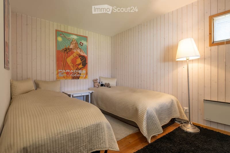 Bedroom. Cozy bedroom with two single beds, nightstand, floor lamp, and decorative poster on the wall.