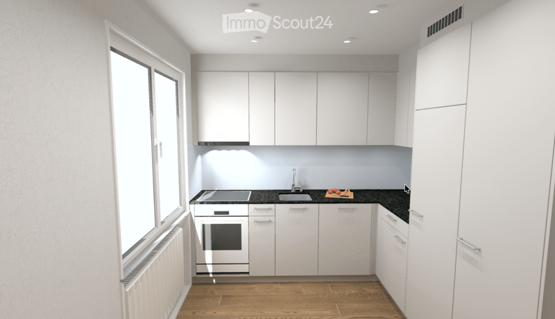 Modern kitchen with white cabinets, dark countertops, and wooden flooring. Features a sink, oven, and a small cutting board with tomatoes and carrots on the counter.