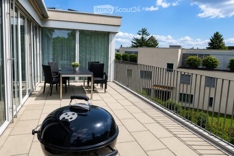 Balcony with tiled floor, metal railing, and outdoor furniture including a table, chairs, a flower pot, and a grill.