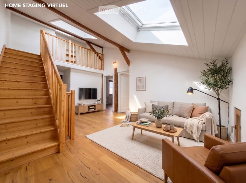 Bright living room with wooden flooring, a staircase leading to an upper level, a sofa, coffee table, armchair, TV, and decorative plants.