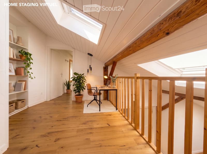 Bright, airy room with wooden floors, white walls, and exposed wooden beams. Features a desk with a chair, laptop, and vase, along with potted plants and shelves with books and decorative items.