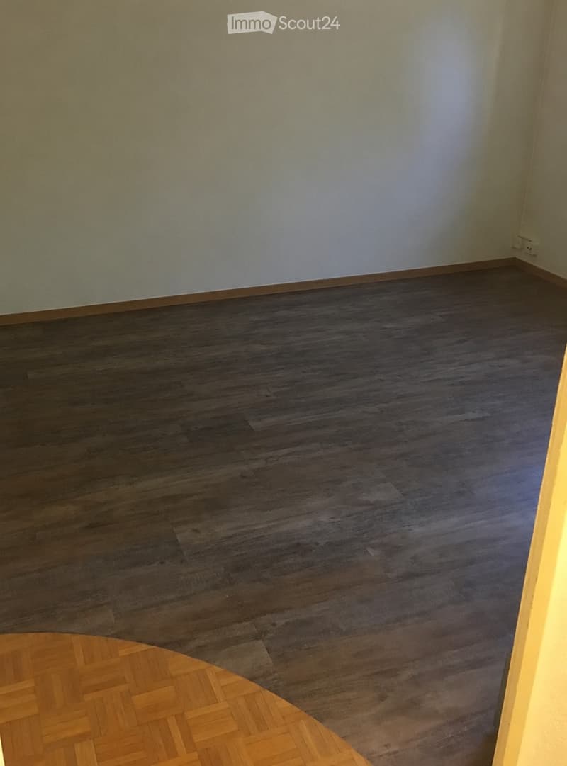 Empty room with dark wooden flooring and light-colored walls. No furniture or equipment visible.
