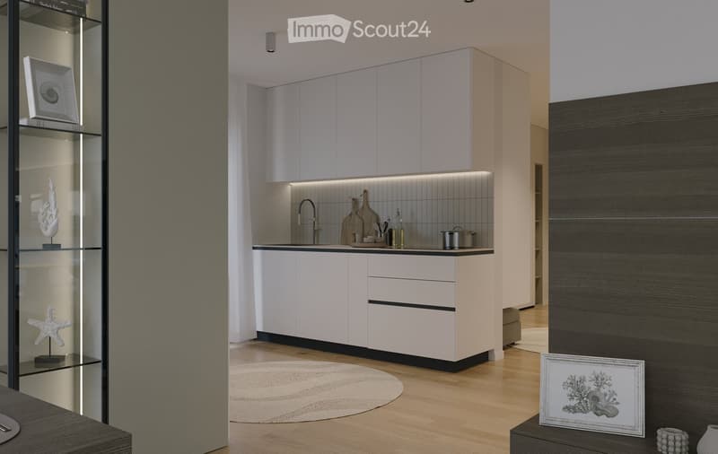Modern kitchen with white cabinets, a central island, and a sleek sink area. The space features a wooden floor, a round rug, and decorative items including framed pictures and a shelf with a starfish.